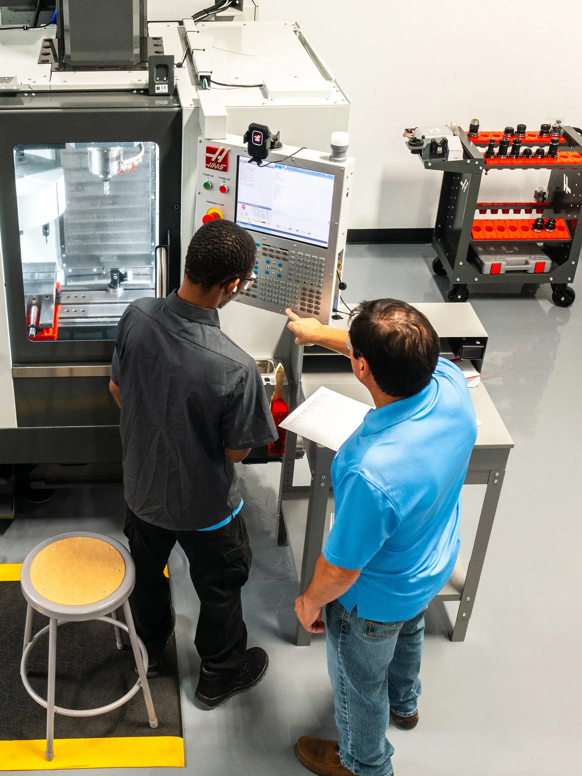 Instructor teaching participant how to use equipment