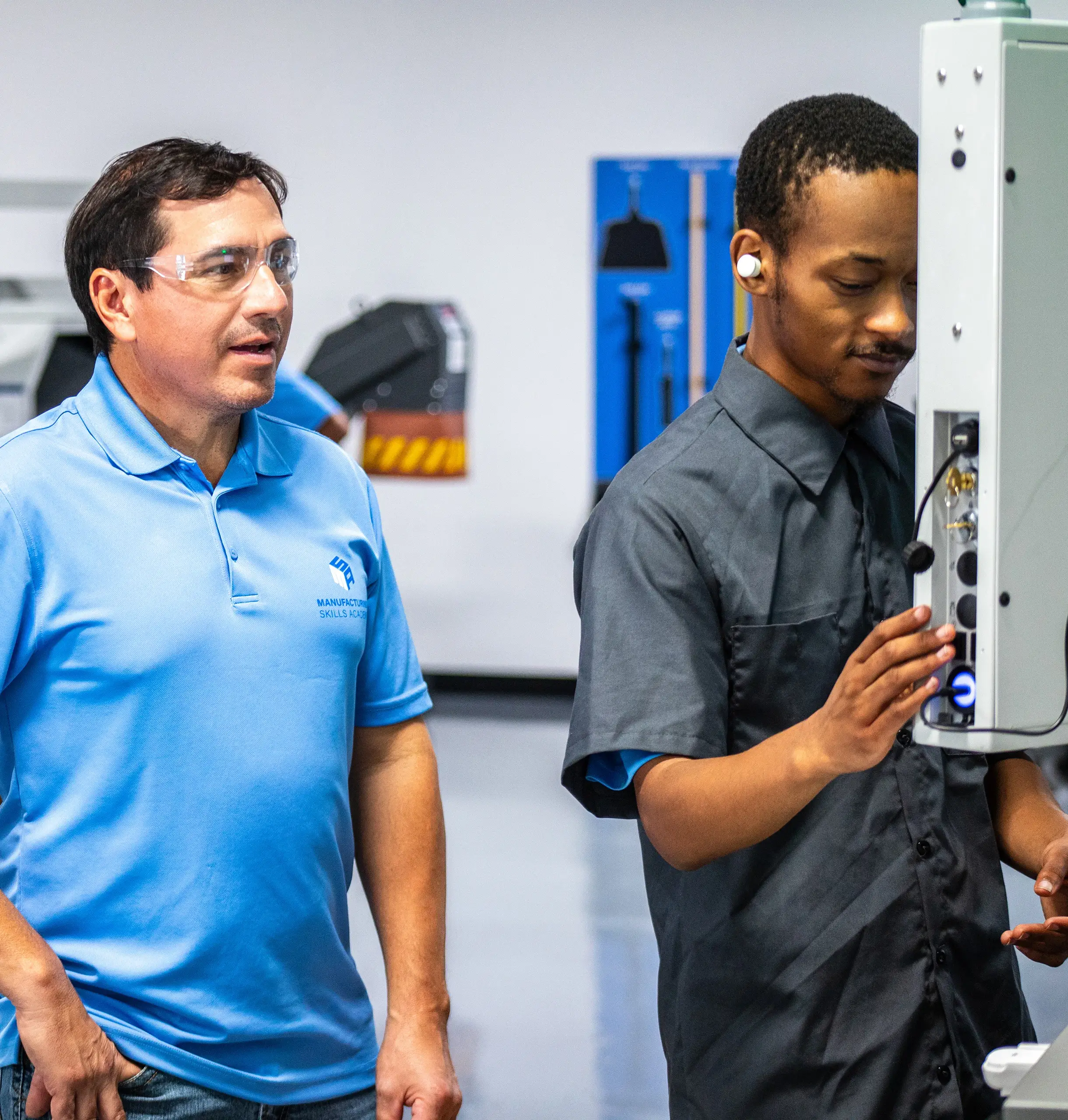 Instructor and participant utilizing CNC machinery